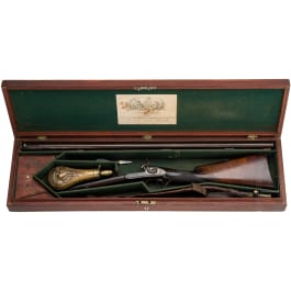 A side-by-side shotgun by J. Manton in London, with case