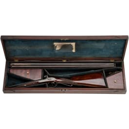 A side-by-side percussion shotgun by Purdey, with case