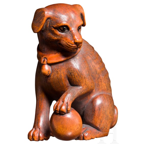 A Japanese netsuke, a dog with a ball, 19th century