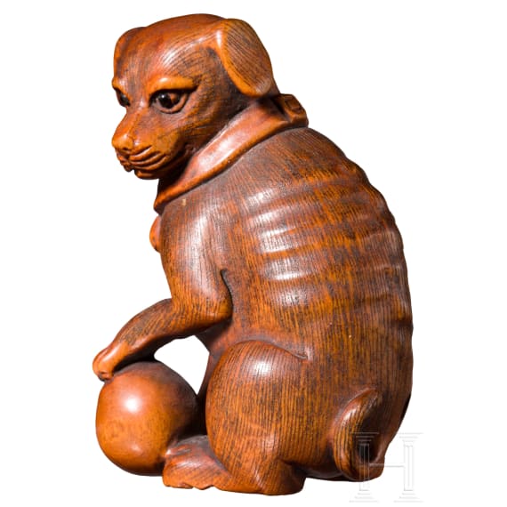 A Japanese netsuke, a dog with a ball, 19th century