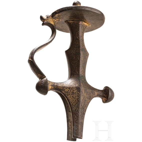 An Indian gilded tulwar grip, 19th century