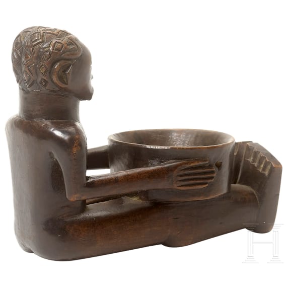 A wooden sculpture of a sitting boy holding a bowl, Luba, Congo