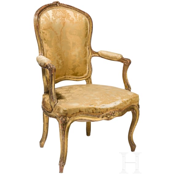 A carved and gilded French Louis XV fauteuil, 18th century