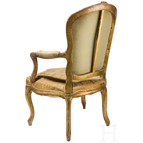 A carved and gilded French Louis XV fauteuil, 18th century