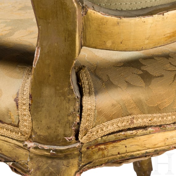 A carved and gilded French Louis XV fauteuil, 18th century
