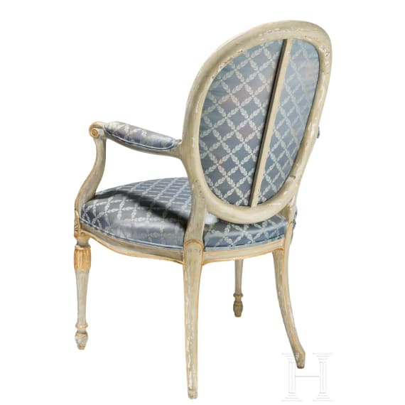 A carved Swedish/Scandinavian neoclassical fauteuil, painted white and partly gilded, early 19th century