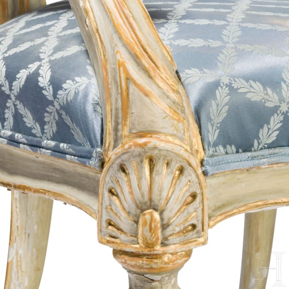 A carved Swedish/Scandinavian neoclassical fauteuil, painted white and partly gilded, early 19th century