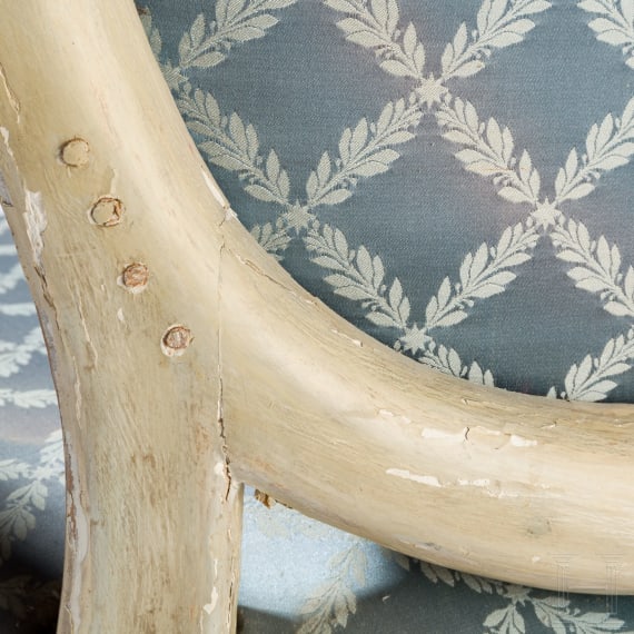 A carved Swedish/Scandinavian neoclassical fauteuil, painted white and partly gilded, early 19th century