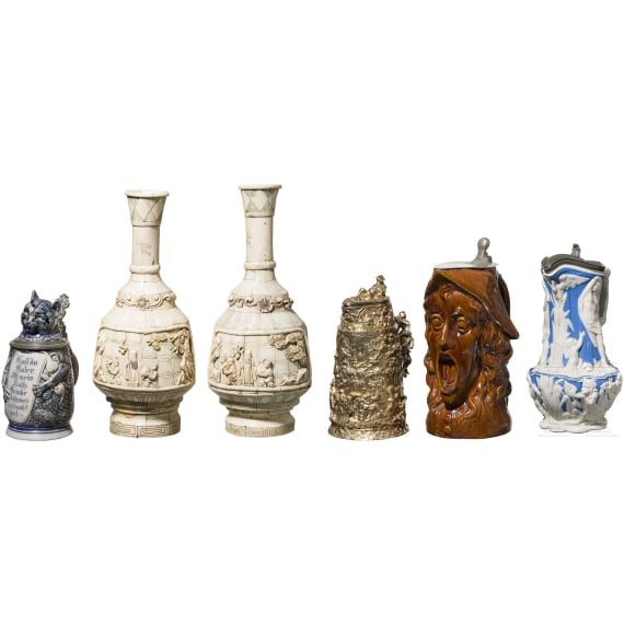 A beer mug, three pitchers and two vases