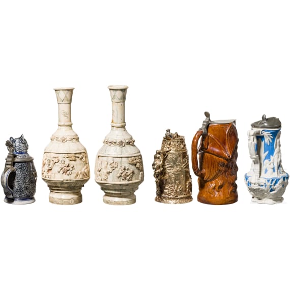 A beer mug, three pitchers and two vases