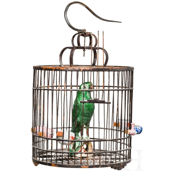 A large Chinese songbird cage, circa 1900, with shells and fayance sculpture of an ara