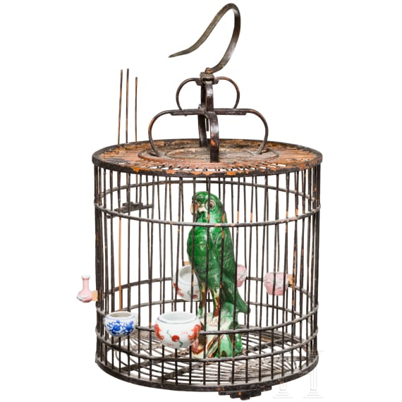 A large Chinese songbird cage, circa 1900, with shells and fayance sculpture of an ara