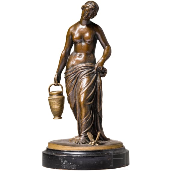 A bronze figure of a nymph fetching water, signed "J.G. Rau"