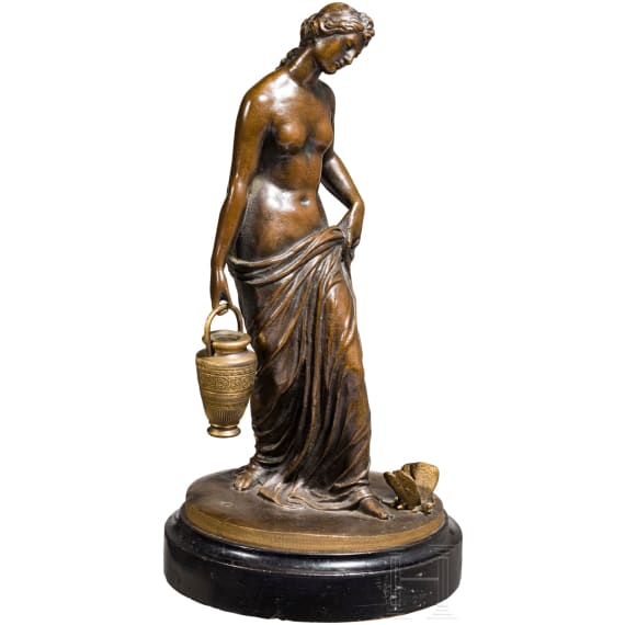 A bronze figure of a nymph fetching water, signed "J.G. Rau"