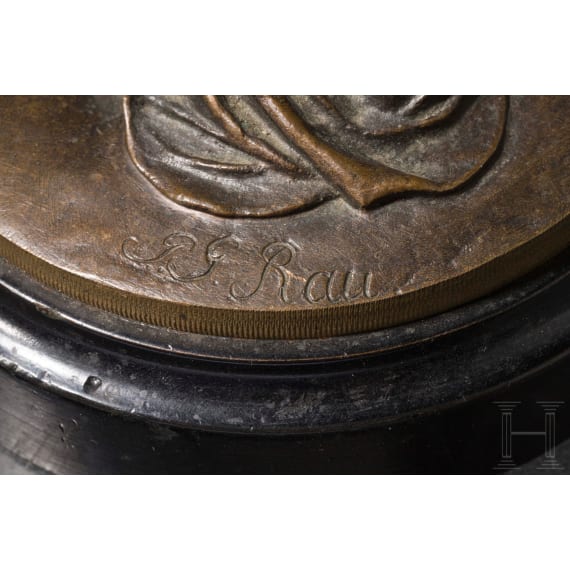 A bronze figure of a nymph fetching water, signed "J.G. Rau"