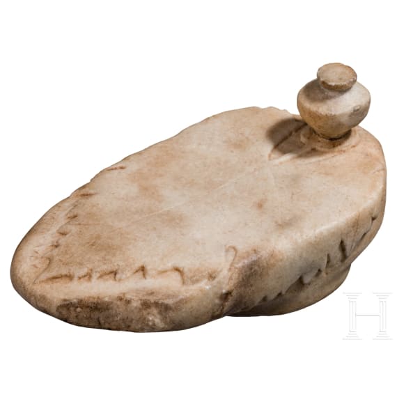 A Greek marble lid with a vine leaf and inscription, 5th - 4th century B.C.