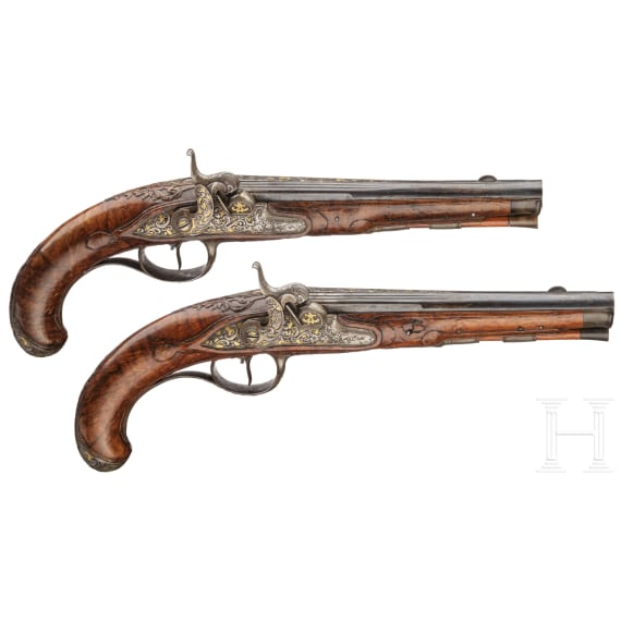 A fine pair of southern German percussion pistols with chiseled mounts, circa 1780