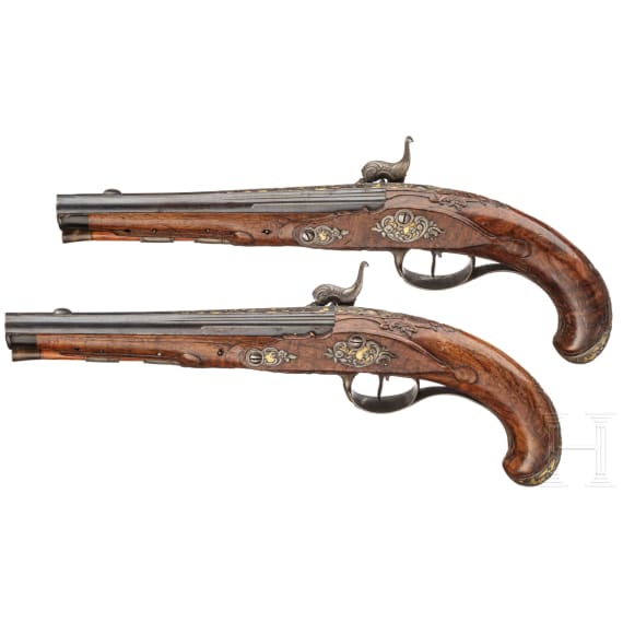 A fine pair of southern German percussion pistols with chiseled mounts, circa 1780