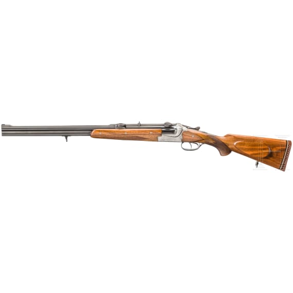A cased double-barrelled over-and-under rifle by Hambrusch with three extra barrels