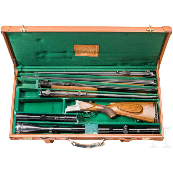 A cased double-barrelled over-and-under rifle by Hambrusch with three extra barrels