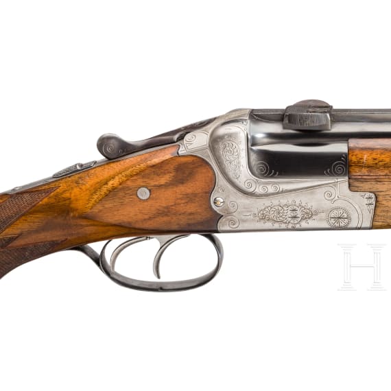 A cased double-barrelled over-and-under rifle by Hambrusch with three extra barrels