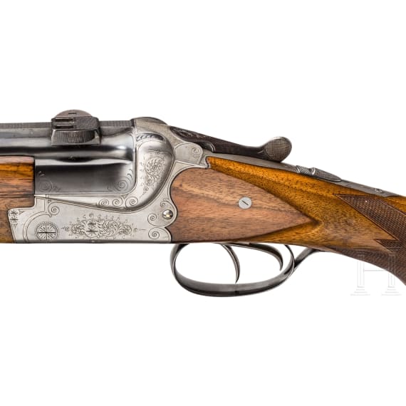 A cased double-barrelled over-and-under rifle by Hambrusch with three extra barrels