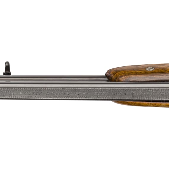 A cased double-barrelled over-and-under rifle by Hambrusch with three extra barrels