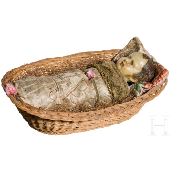 A South German swaddled baby in a basket, 19th century