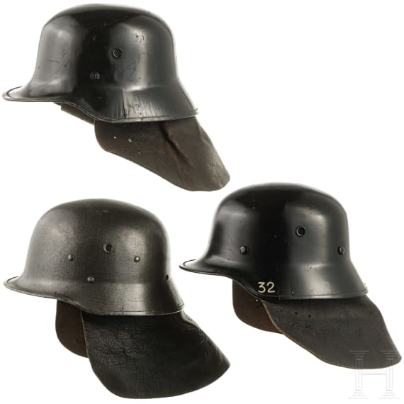 Three fire helmets with shoulder boards, 1950s - 1970s