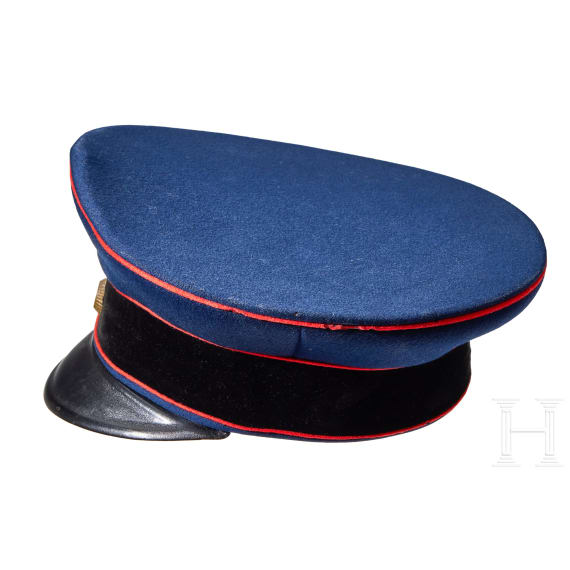 A visor cap and assorted insignia
