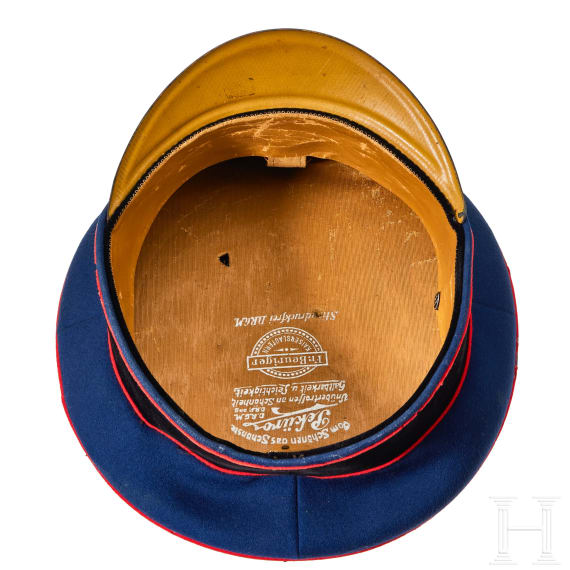 A visor cap and assorted insignia