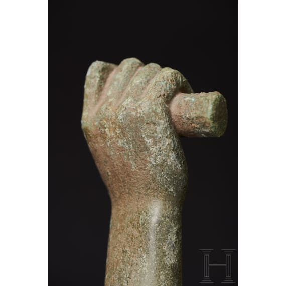 A Roman bronze fragment of an arm and a club on a pedestal, 1st - 2nd century