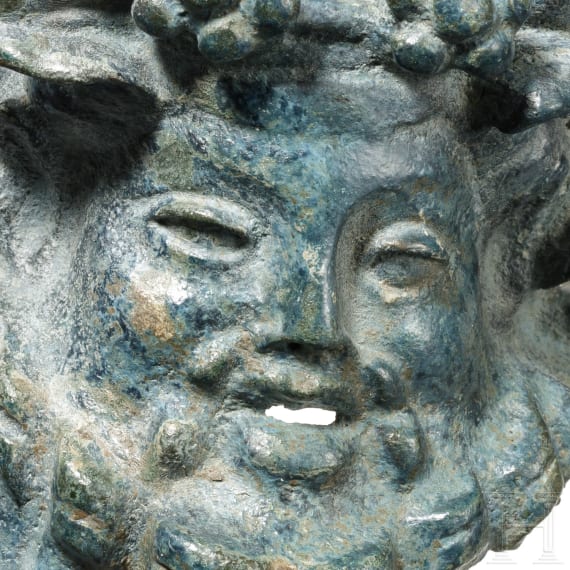 A Roman furniture fitting with the head of Bacchus, 1st - 2nd century