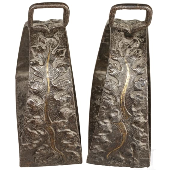 A pair of partially gilded and relief-carved Italian stirrups, 16th century