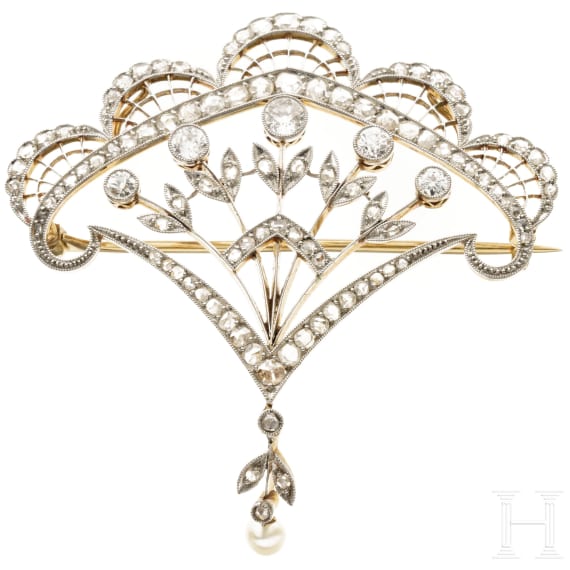 A fan-shaped gold and diamond brooch with a pearl
