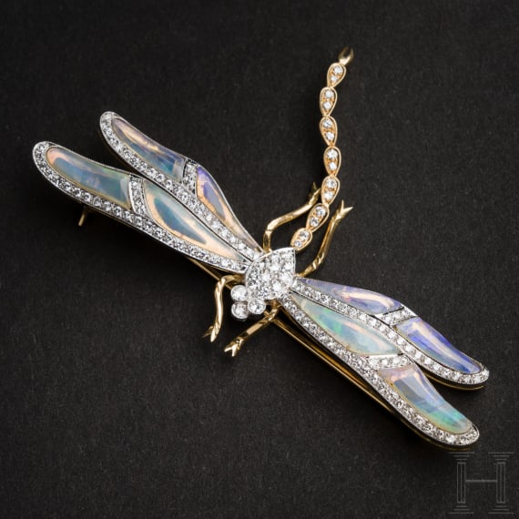 A gold and diamond dragonfly-shaped brooch
