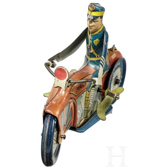 A Marx Toys motorcycle policeman with windup key