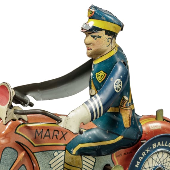 A Marx Toys motorcycle policeman with windup key