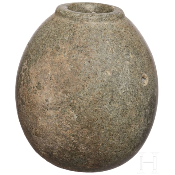 An Egyptian pre-dynastic stone mace head, 3rd millennium B.C.