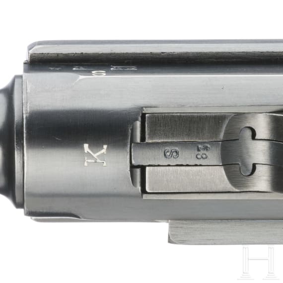 A Luger pistol by Mauser, code "K - S/42", with two matching-number mags and holster
