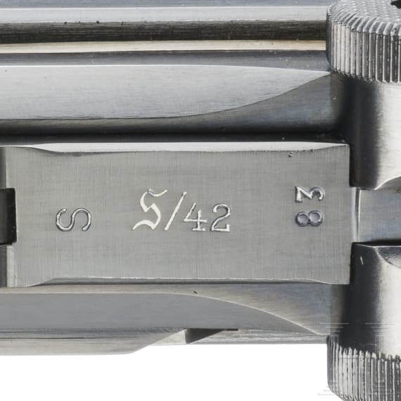 A Luger pistol by Mauser, code "K - S/42", with two matching-number mags and holster