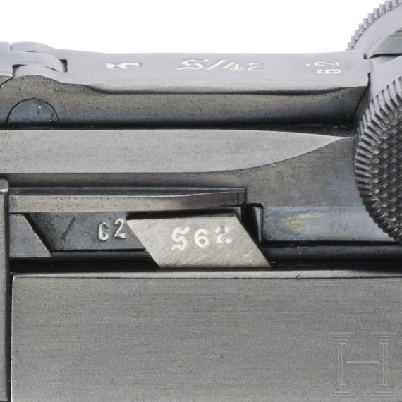 A Luger pistol by Mauser, code "K - S/42", with two matching-number mags and holster