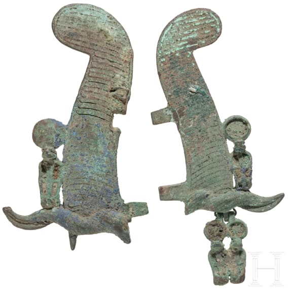 Two halves of Egyptian feather crowns with Uraeus serpents, bronze, 2nd - 1st millennium B.C.