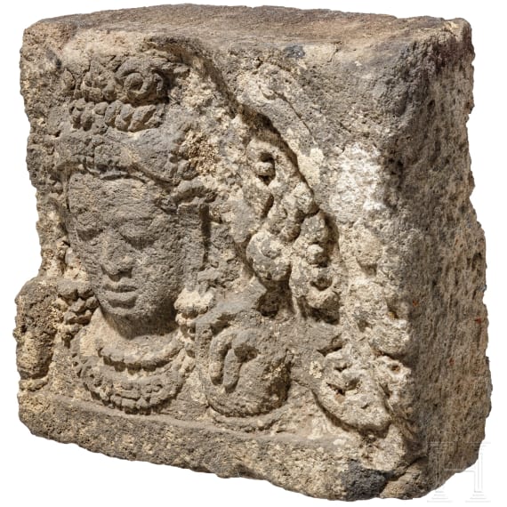 A Javanese relief stone with the head of Bodhisattva, 9th century