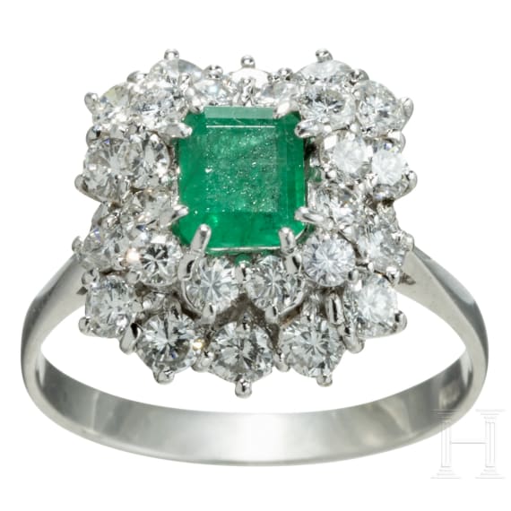 An emerald and diamond white gold ring