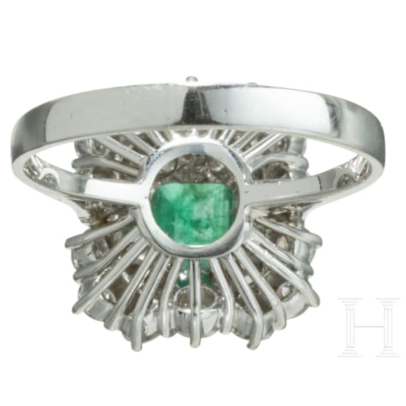 An emerald and diamond white gold ring