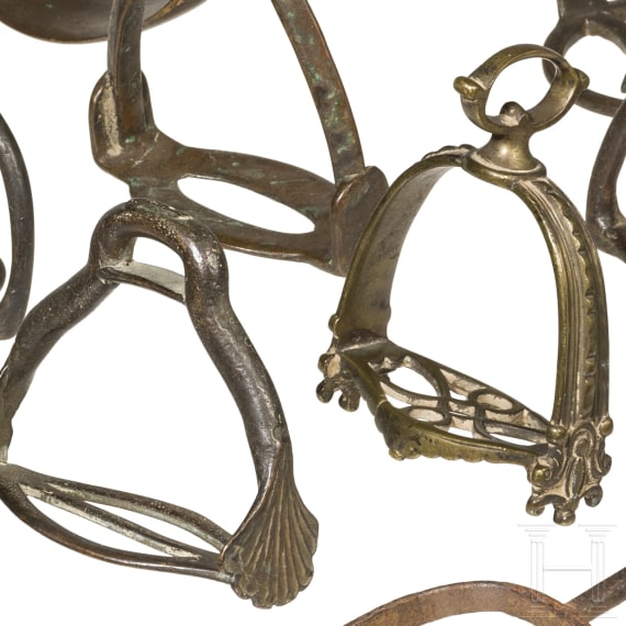 15 German iron and brass stirrups and one iron spore, 16th - 18th century