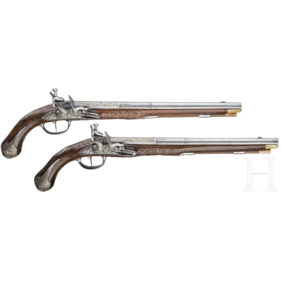 A magnificent pair of German chiselled flintlock pistols, circa 1780