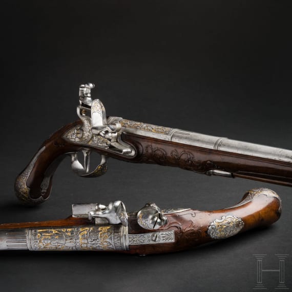 A magnificent pair of German chiselled flintlock pistols, circa 1780