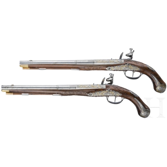 A magnificent pair of German chiselled flintlock pistols, circa 1780